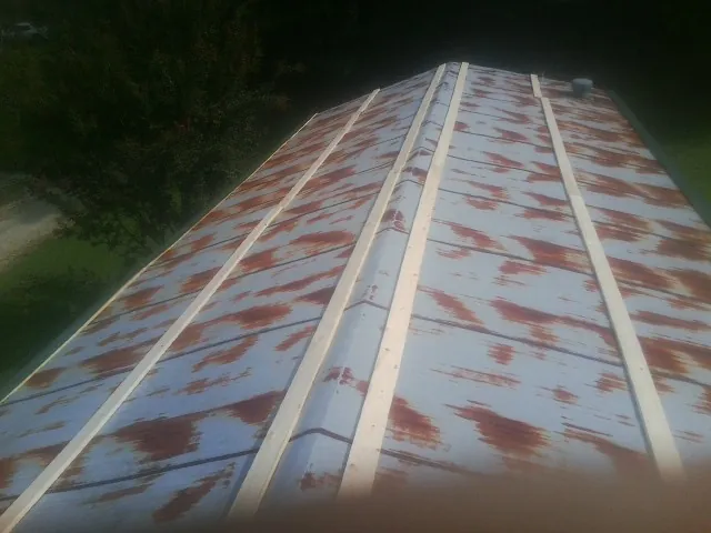 Rusted metal roof panels with new wood purlins before replacement — Storm Damage Roof Repair in York Beach by Roofing Brothers