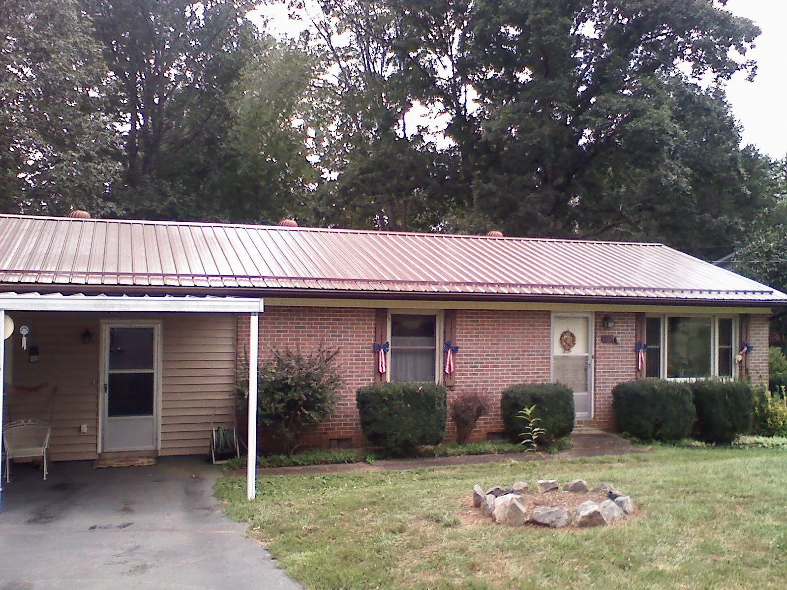 Bronze metal roof and carport on a brick ranch home — Roof Repair work by our crew in York Beach