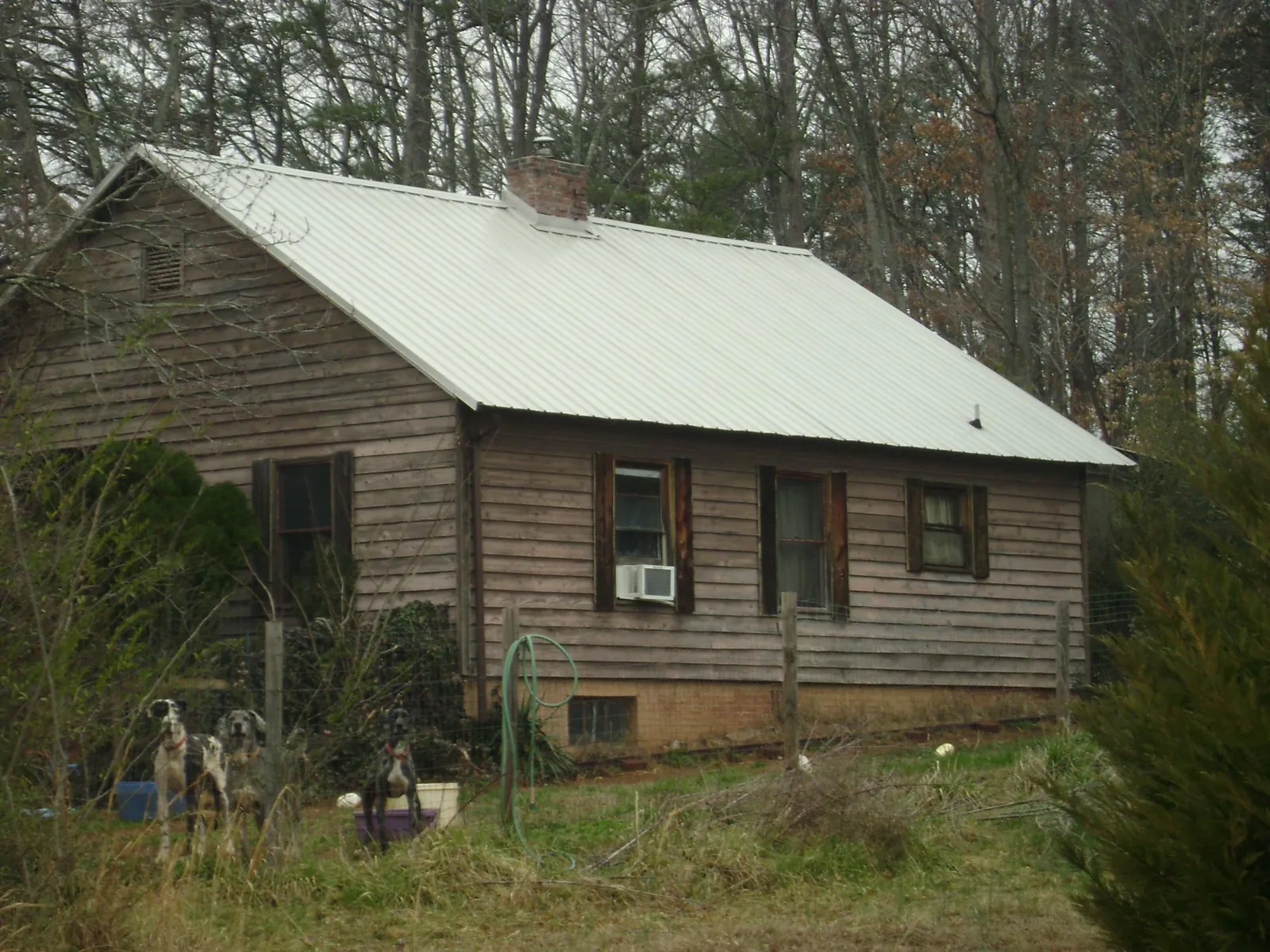 White metal roof on an old wood sided farmhouse, from a Metal Roof Installation job in York Beach